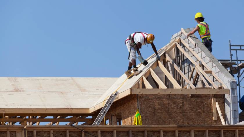 Workers are working on the roof at construction